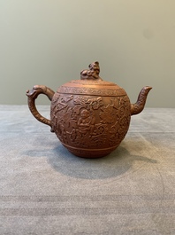 A Chinese Yixing stoneware teapot with boys among flower scrolls, Kangxi