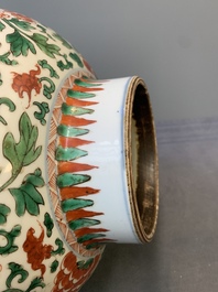 A Chinese wucai 'boy and peony scroll' vase and cover, 17th C.