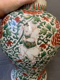 A Chinese wucai 'boy and peony scroll' vase and cover, 17th C.