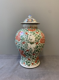 A Chinese wucai 'boy and peony scroll' vase and cover, 17th C.
