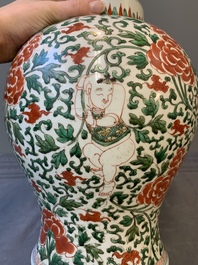 A Chinese wucai 'boy and peony scroll' vase and cover, 17th C.