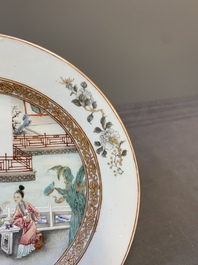A fine pair of Chinese Canton famille rose 'ladies in the garden' plates, Yongzheng/Qianlong