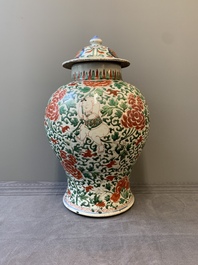 A Chinese wucai 'boy and peony scroll' vase and cover, 17th C.