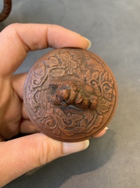 A Chinese Yixing stoneware teapot with boys among flower scrolls, Kangxi