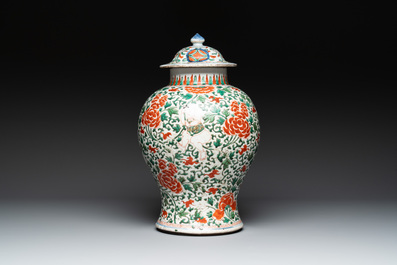 A Chinese wucai 'boy and peony scroll' vase and cover, 17th C.