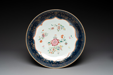 A large Chinese famille rose blue-ground punch bowl and dish, Qianlong