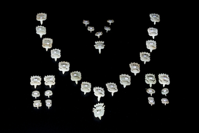 34 Chinese white and celadon jade phoenix-form hat ornaments, 19th C.