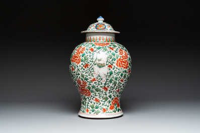 A Chinese wucai 'boy and peony scroll' vase and cover, 17th C.