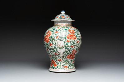 A Chinese wucai 'boy and peony scroll' vase and cover, 17th C.