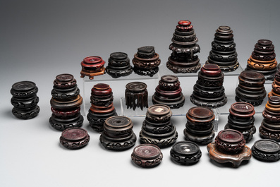 A large collection of 91 Chinese wooden stands, 19/20th C.