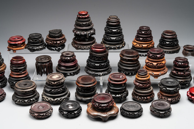 A large collection of 91 Chinese wooden stands, 19/20th C.
