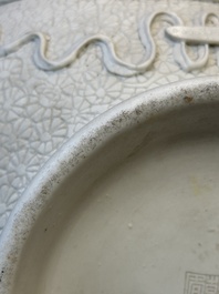 A Chinese white-glazed biscuit 'hu' vase with dragons, Qianlong mark, 19/20th C.