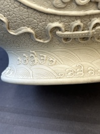 A Chinese white-glazed biscuit 'hu' vase with dragons, Qianlong mark, 19/20th C.