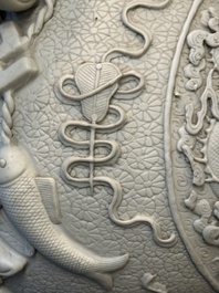 A Chinese white-glazed biscuit 'hu' vase with dragons, Qianlong mark, 19/20th C.