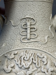 A Chinese white-glazed biscuit 'hu' vase with dragons, Qianlong mark, 19/20th C.