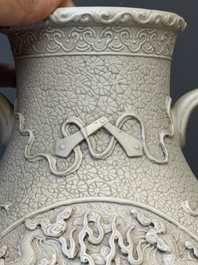 A Chinese white-glazed biscuit 'hu' vase with dragons, Qianlong mark, 19/20th C.