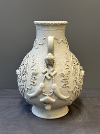 A Chinese white-glazed biscuit 'hu' vase with dragons, Qianlong mark, 19/20th C.