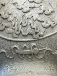 A Chinese white-glazed biscuit 'hu' vase with dragons, Qianlong mark, 19/20th C.