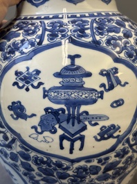 A Chinese blue and white 'antiquities and peony scrolls' vase and cover, Kangxi