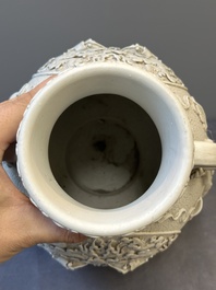 A Chinese white-glazed biscuit 'hu' vase with dragons, Qianlong mark, 19/20th C.
