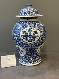 A Chinese blue and white 'antiquities and peony scrolls' vase and cover, Kangxi