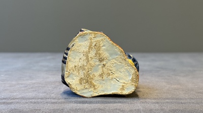 A polychrome Dutch Delft model of a boy rolling a 'wijn azijn' barrel, 18th C.