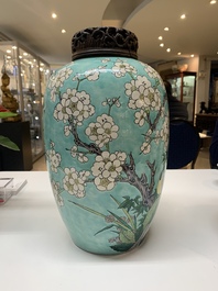 A pair of fine Chinese famille verte turquoise-ground 'magpie and prunus' jars with reticulated wooden covers, 19th C.