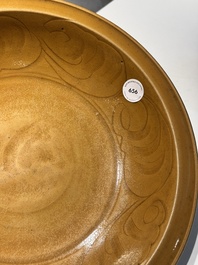 A Chinese incised brown-glazed Longquan dish with floral design, Ming