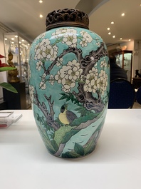 A pair of fine Chinese famille verte turquoise-ground 'magpie and prunus' jars with reticulated wooden covers, 19th C.