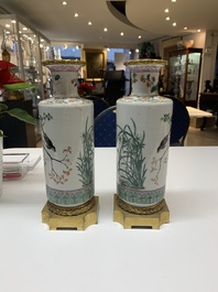 A pair of Chinese famille rose gilt-bronze-mounted 'birds among flowering branches' vases, 19th C.