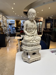 An extremely rare Chinese Swatow cream-glazed seated Buddha, Xuande mark, Ming