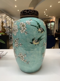 A pair of fine Chinese famille verte turquoise-ground 'magpie and prunus' jars with reticulated wooden covers, 19th C.