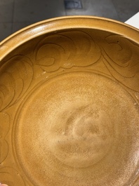 A Chinese incised brown-glazed Longquan dish with floral design, Ming