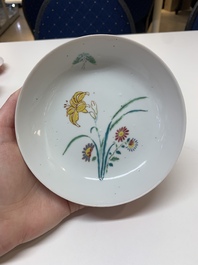 Three Chinese ruby-ground famille rose plates and a cup, 19th C.