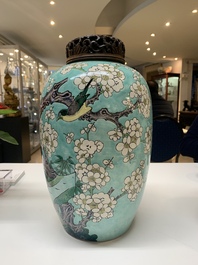 A pair of fine Chinese famille verte turquoise-ground 'magpie and prunus' jars with reticulated wooden covers, 19th C.