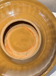 A Chinese incised brown-glazed Longquan dish with floral design, Ming