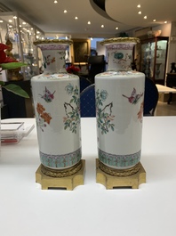 A pair of Chinese famille rose gilt-bronze-mounted 'birds among flowering branches' vases, 19th C.