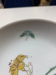 Three Chinese ruby-ground famille rose plates and a cup, 19th C.
