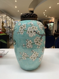 A pair of fine Chinese famille verte turquoise-ground 'magpie and prunus' jars with reticulated wooden covers, 19th C.