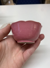 Three Chinese ruby-ground famille rose plates and a cup, 19th C.