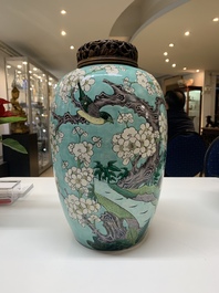 A pair of fine Chinese famille verte turquoise-ground 'magpie and prunus' jars with reticulated wooden covers, 19th C.