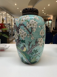 A pair of fine Chinese famille verte turquoise-ground 'magpie and prunus' jars with reticulated wooden covers, 19th C.