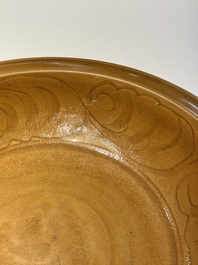 A Chinese incised brown-glazed Longquan dish with floral design, Ming