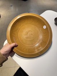 A Chinese incised brown-glazed Longquan dish with floral design, Ming
