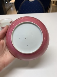 Three Chinese ruby-ground famille rose plates and a cup, 19th C.
