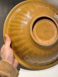 A Chinese incised brown-glazed Longquan dish with floral design, Ming
