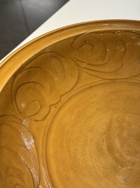 A Chinese incised brown-glazed Longquan dish with floral design, Ming