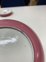Three Chinese ruby-ground famille rose plates and a cup, 19th C.