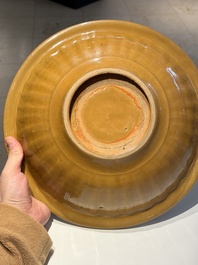 A Chinese incised brown-glazed Longquan dish with floral design, Ming
