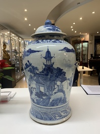 A near pair of Chinese blue and white 'landscape' vases and covers, 19th C.